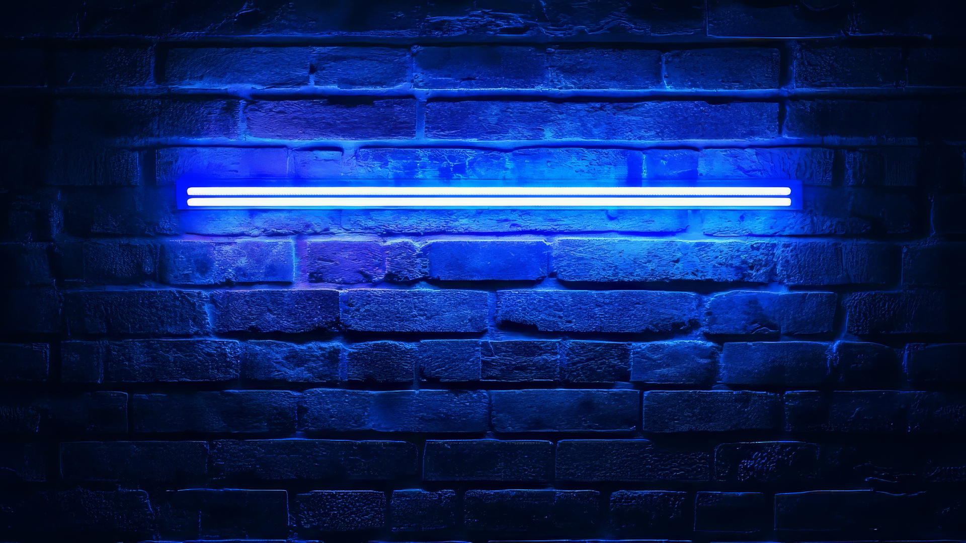 Navy blue wallpaper with a glowing retro neon sign on a dark brick wall