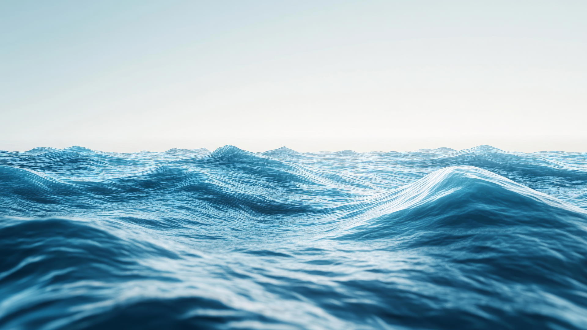 A serene blue wallpaper of a tranquil ocean with gentle waves under a clear sky.