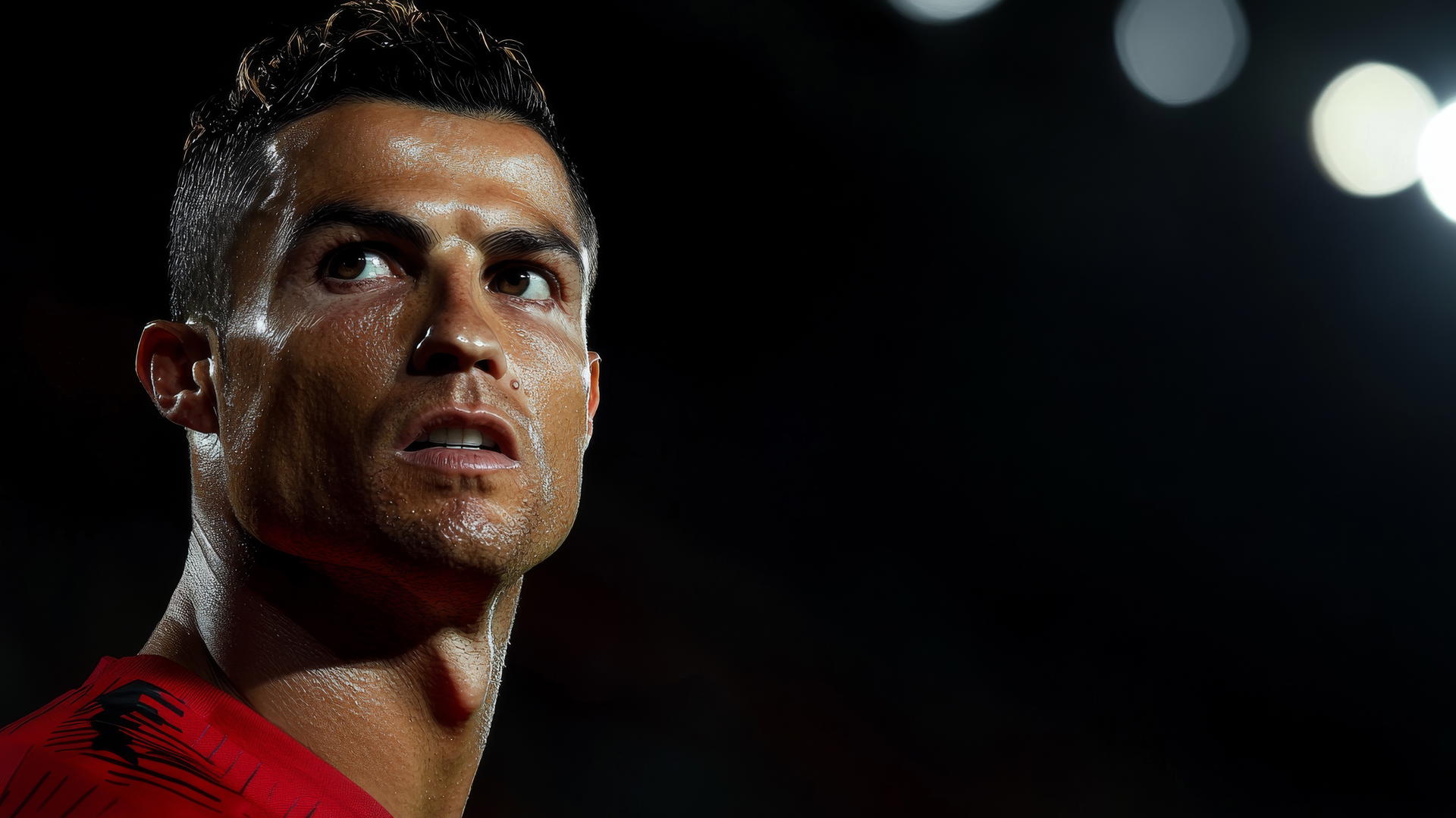 Cristiano Ronaldo celebrating goal, intense expression, minimal black background