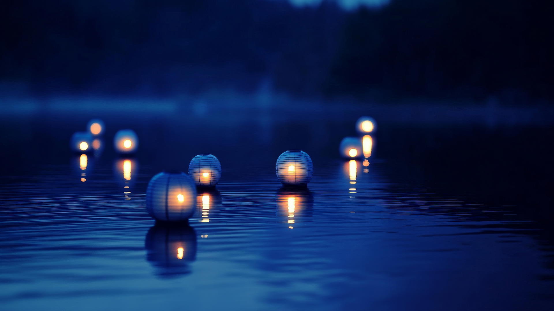aesthetic blue wallpaper with floating lanterns on a twilight lake