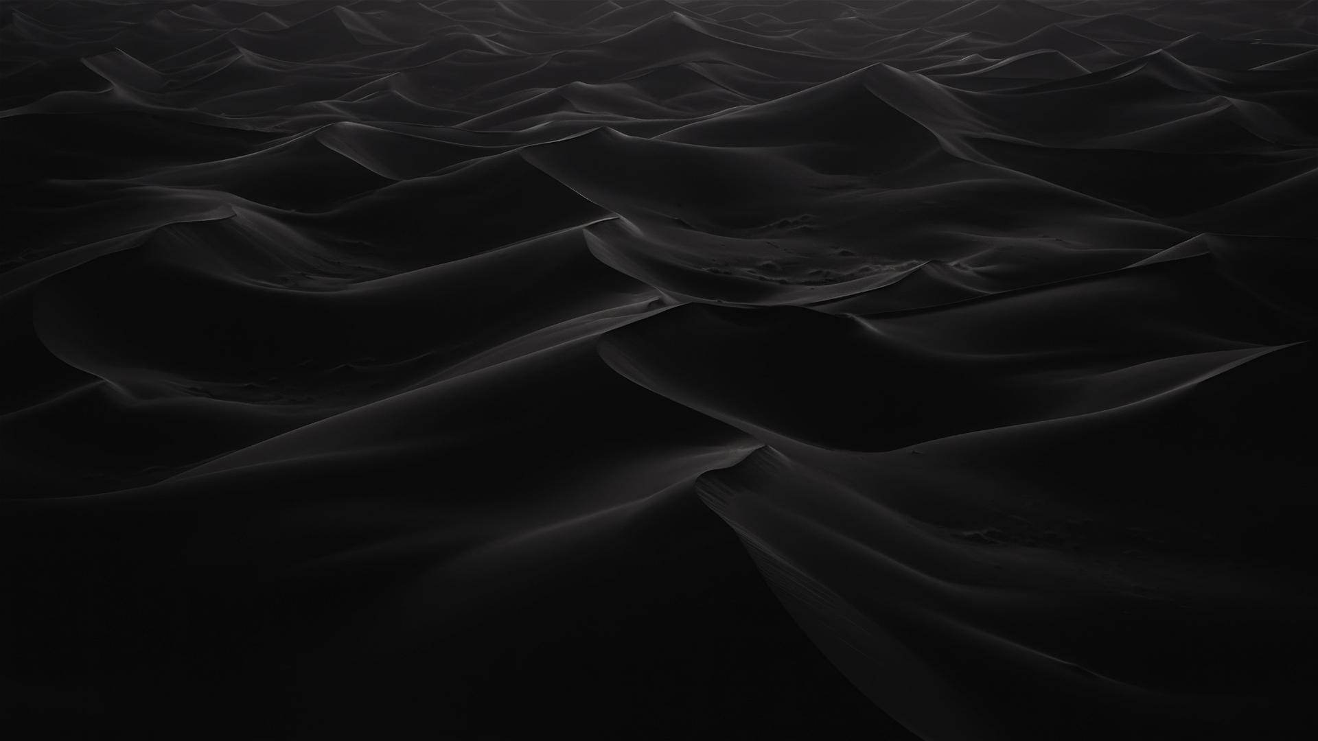 Black sand dunes under starlight at night, subtle texture shifts