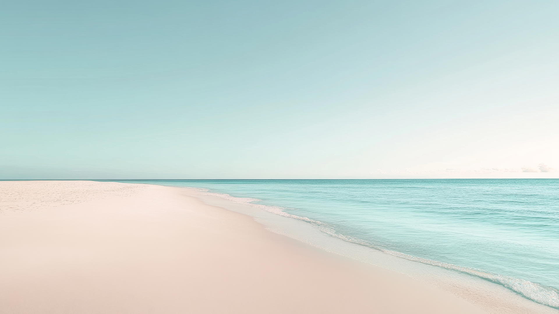aesthetic beach wallpaper with smooth sand, pale blue water, and a cloudless sky