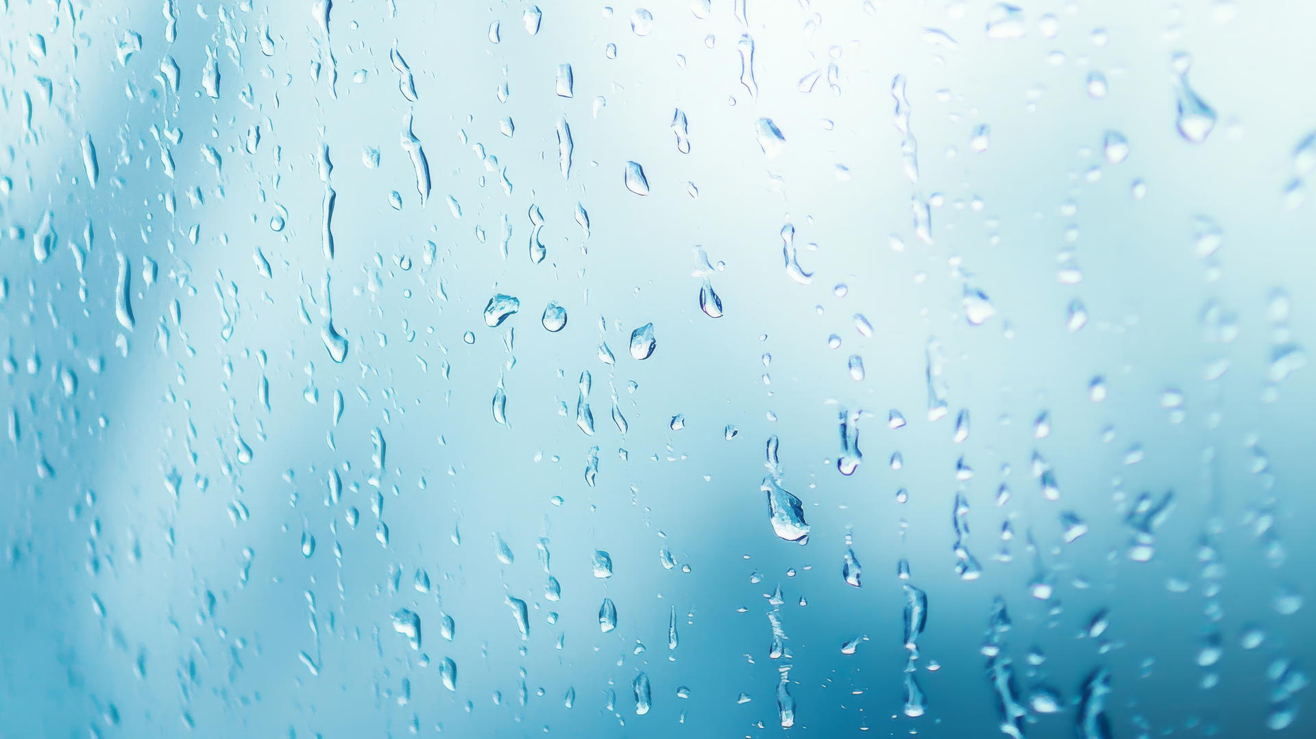 light blue wallpaper with gentle rain droplets on window pane