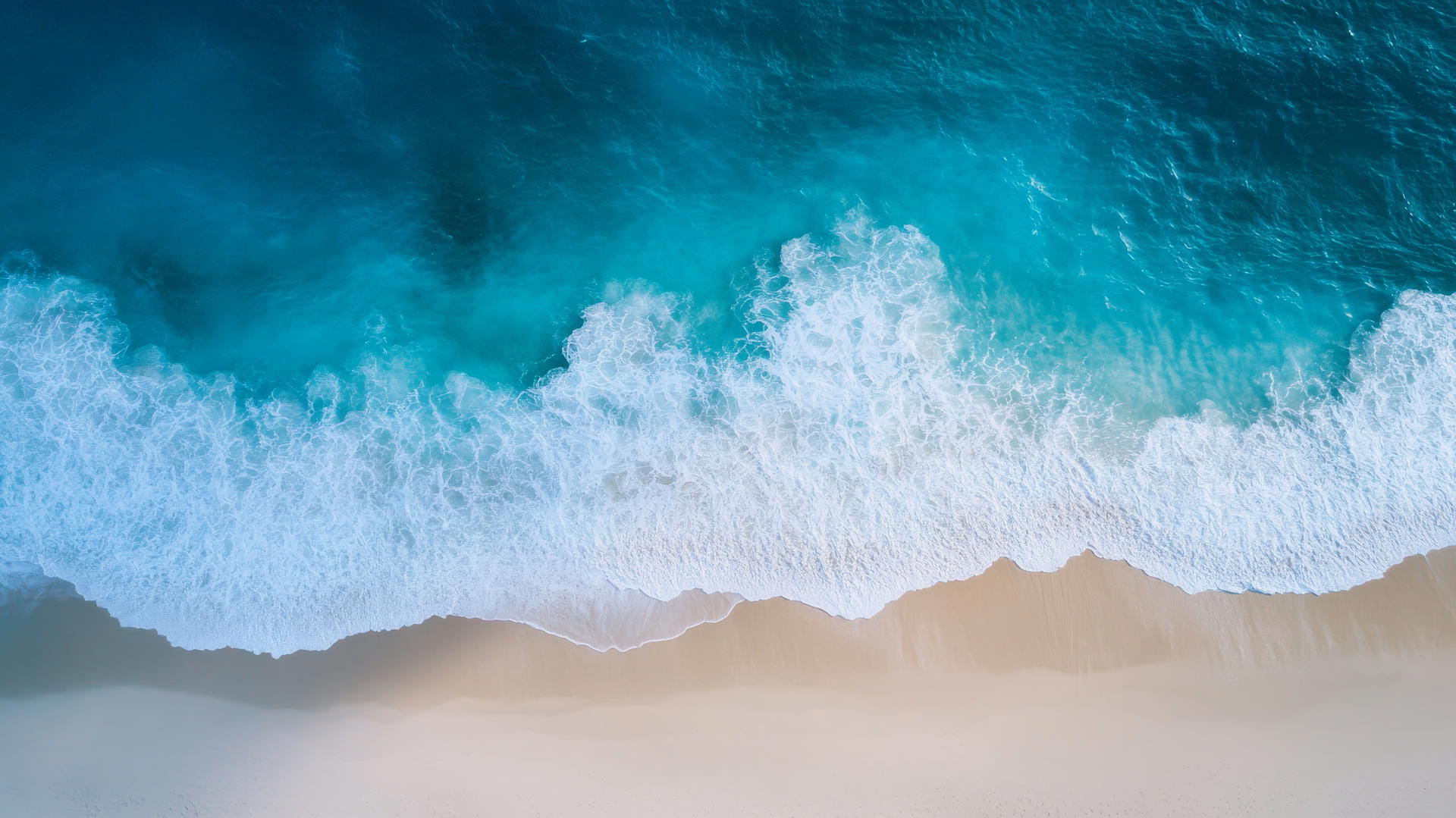 Overhead drone shot of a beach with white sand and blue ocean waves, beach pictures wallpaper