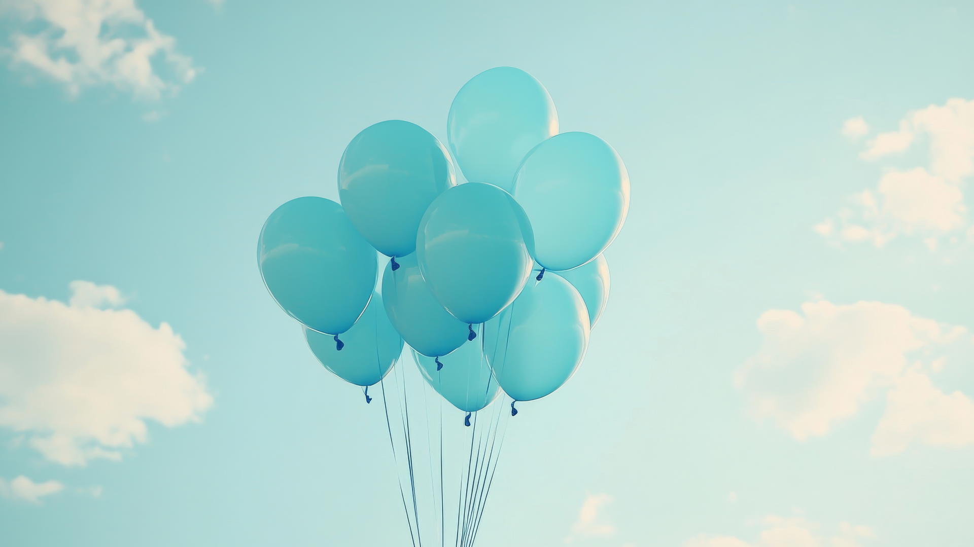 baby blue wallpaper with a bouquet of helium balloons floating against a light sky