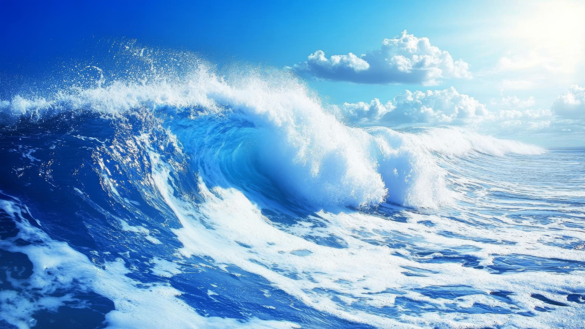 Blue and white wallpaper featuring ocean waves crashing with white foam and spray