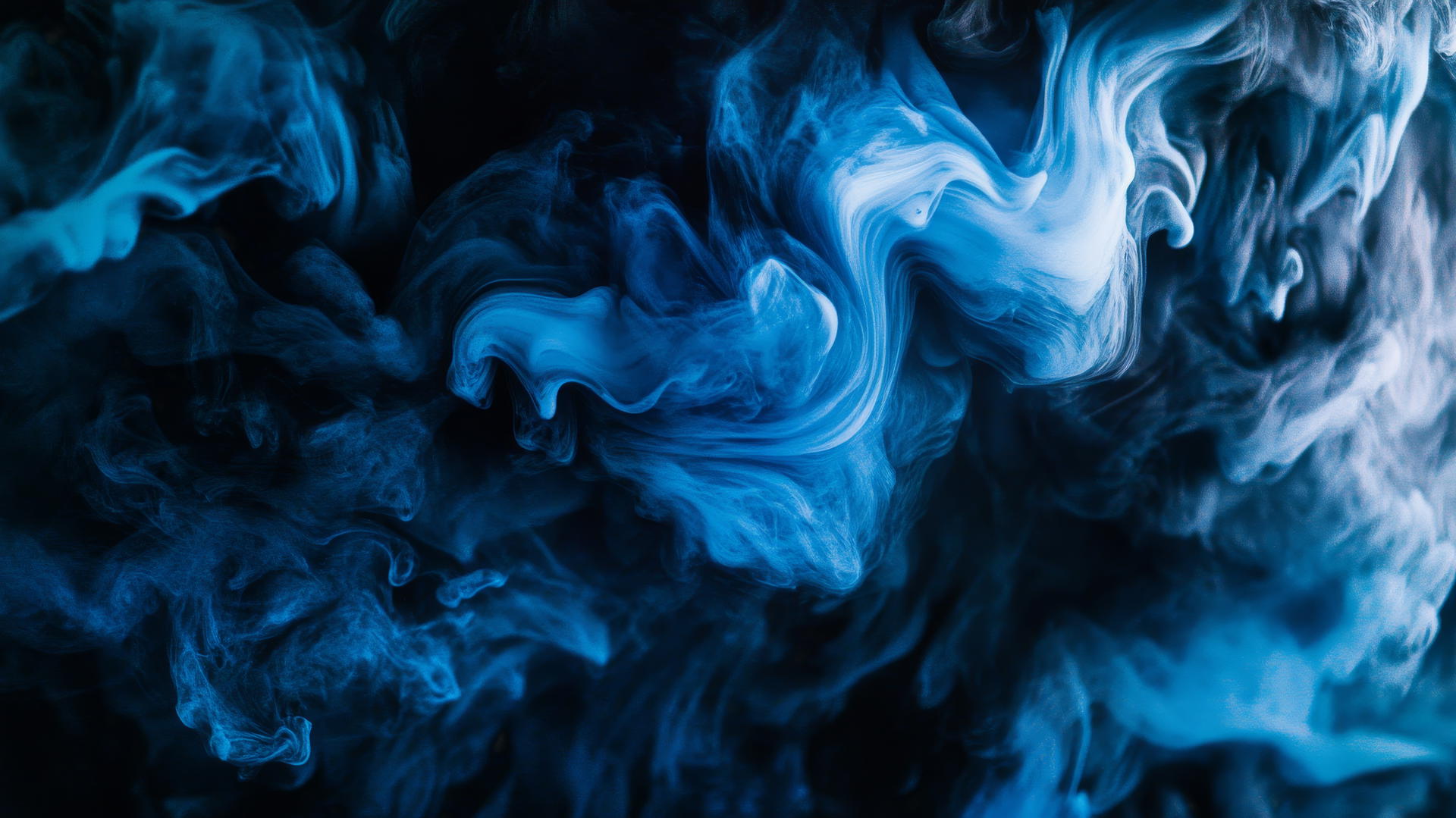 Black and blue wallpaper with ink swirls creating abstract shapes.