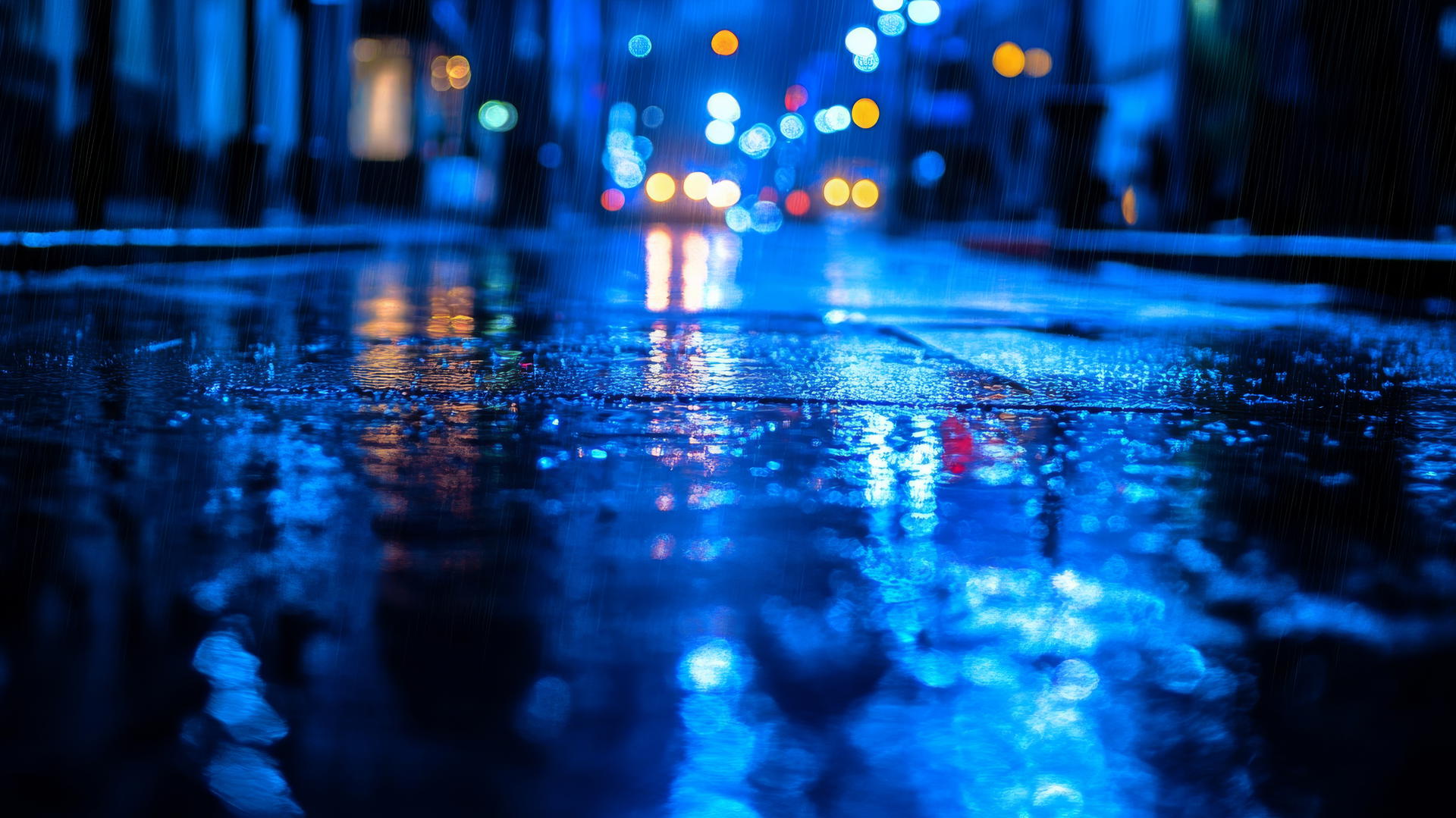 wallpaper blue showing a rainy city street with reflections on wet pavement