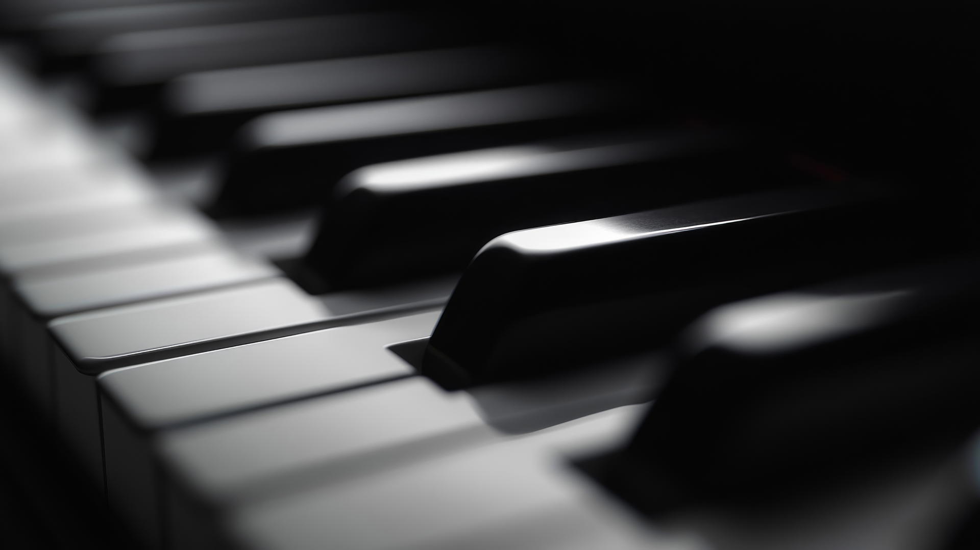 Aesthetic black wallpaper of close-up black piano keys with gentle shadows