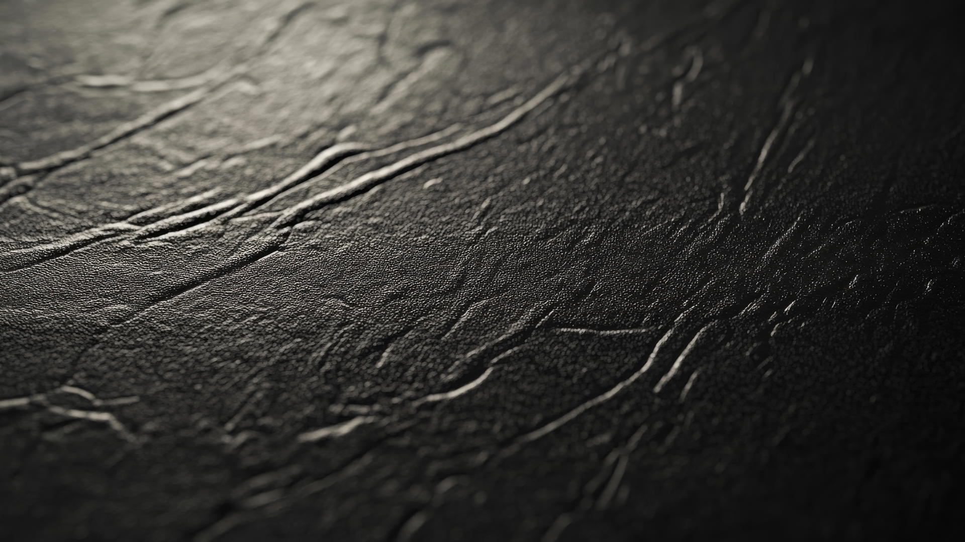 Black wallpaper aesthetic with close-up of detailed black leather texture