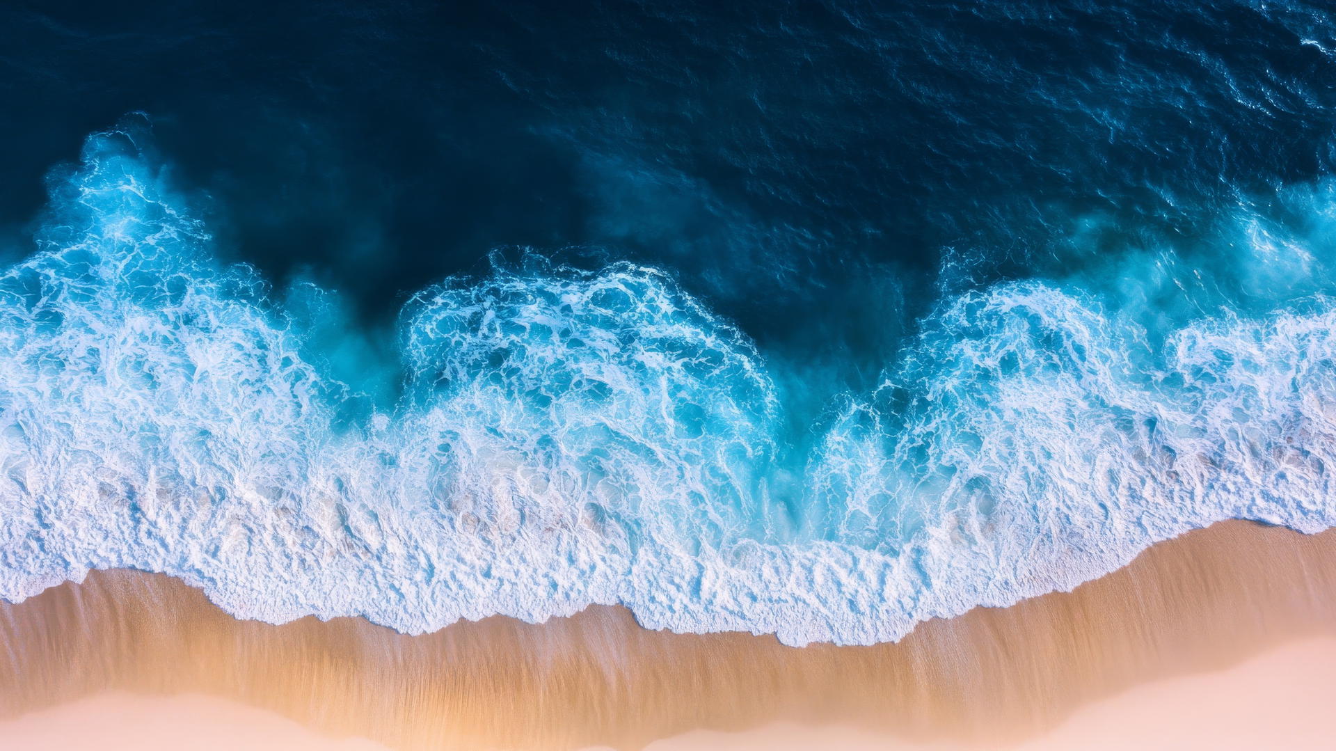 overhead drone shot of a serene beach showing white sand and blue ocean waves, beach pictures wallpaper