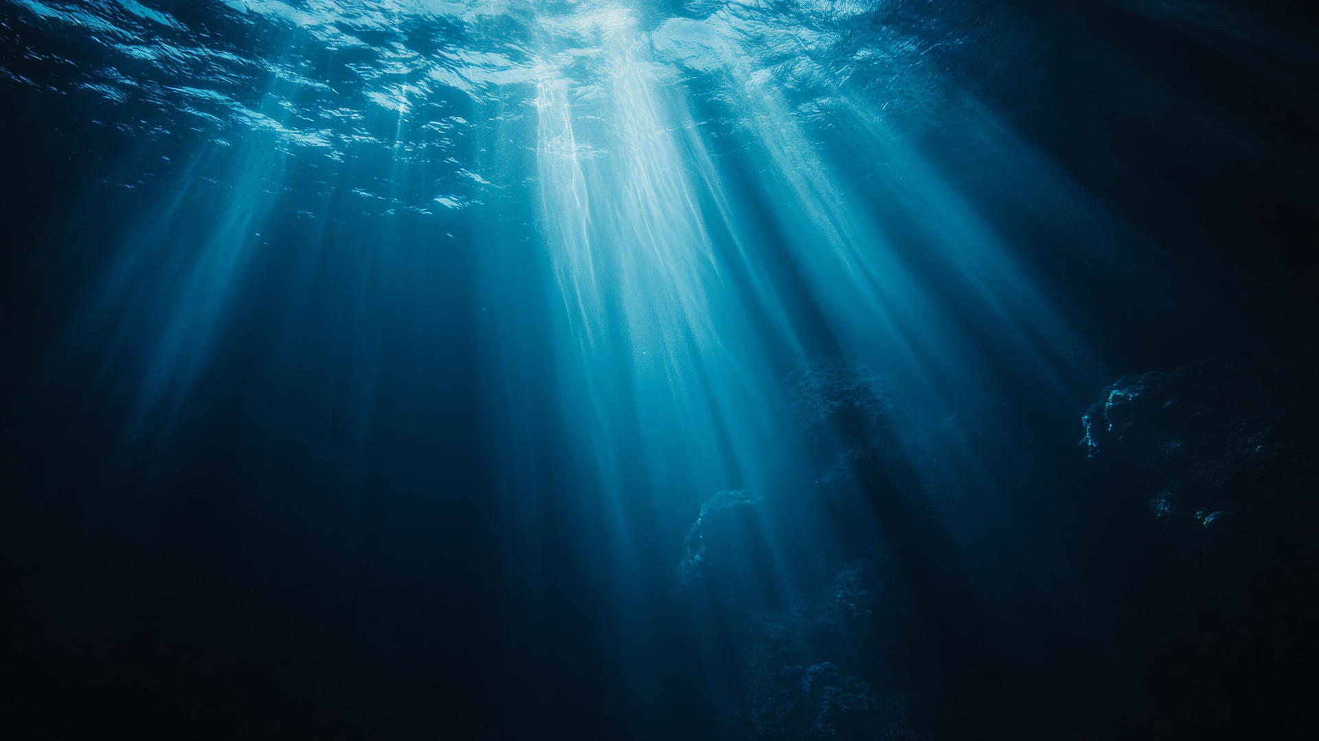 Dark blue aesthetic wallpaper of deep ocean abyss with light rays