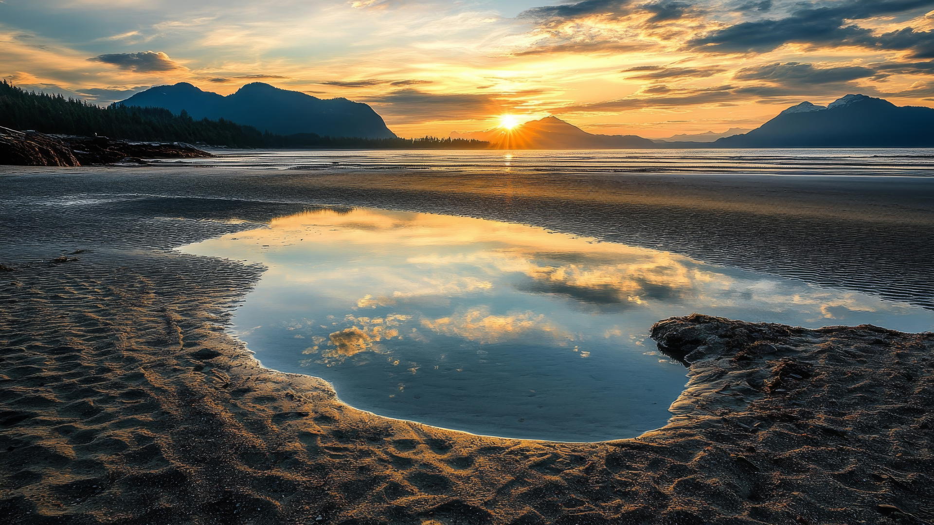 Beach pictures wallpaper with tide pools, sunset, smooth sand, and mountains.