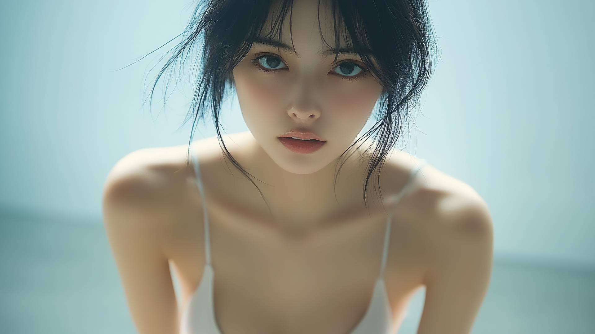 Isolated shot of a serene Asian girl kneeling and smiling, seen from below.