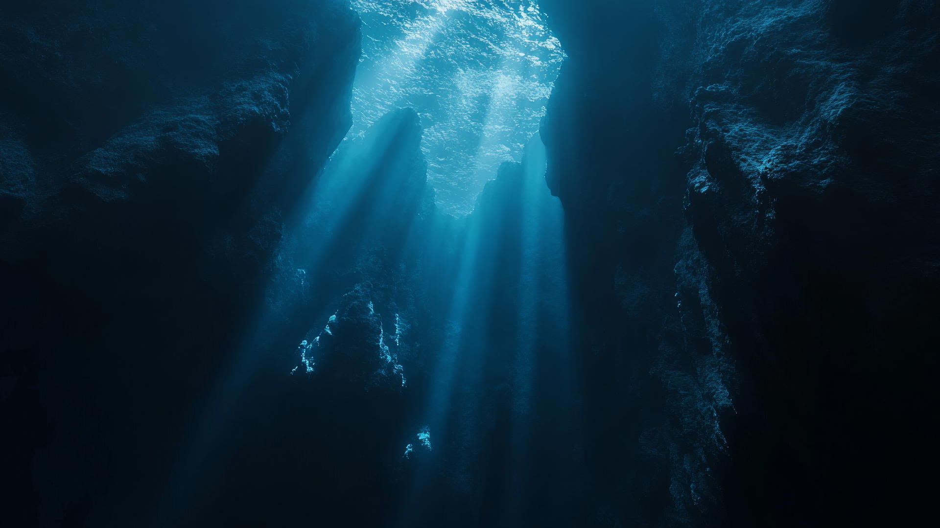 Dark blue aesthetic wallpaper of deep ocean abyss with light rays