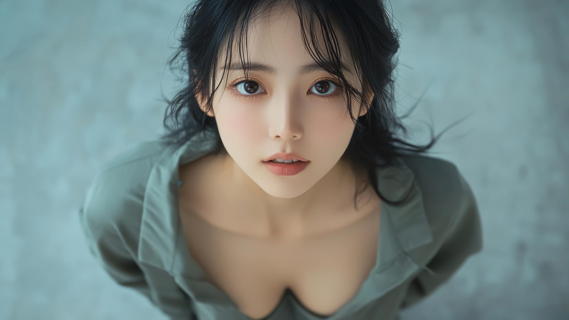 Asian fashion model kneeling and smiling, seen from below.