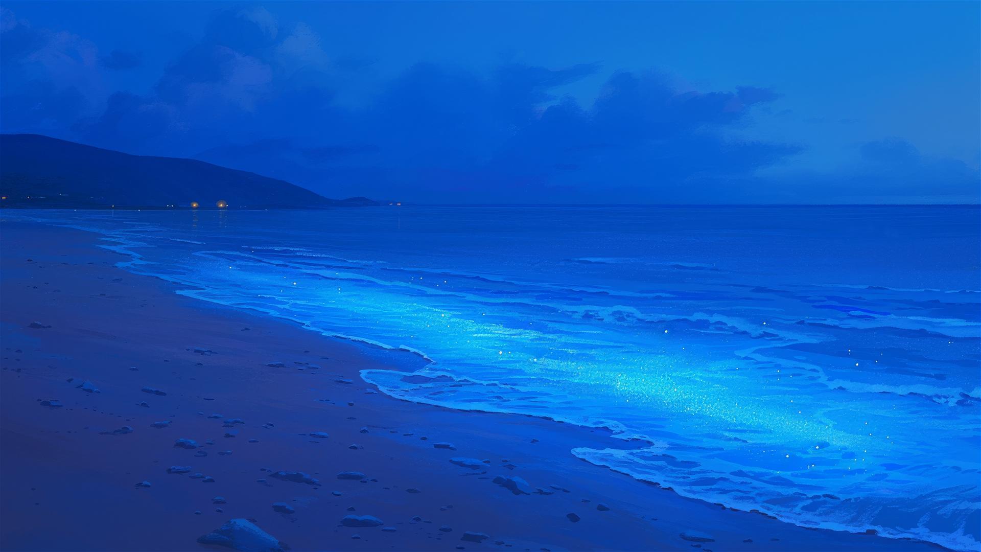 Glowing blue waves on serene nighttime beach