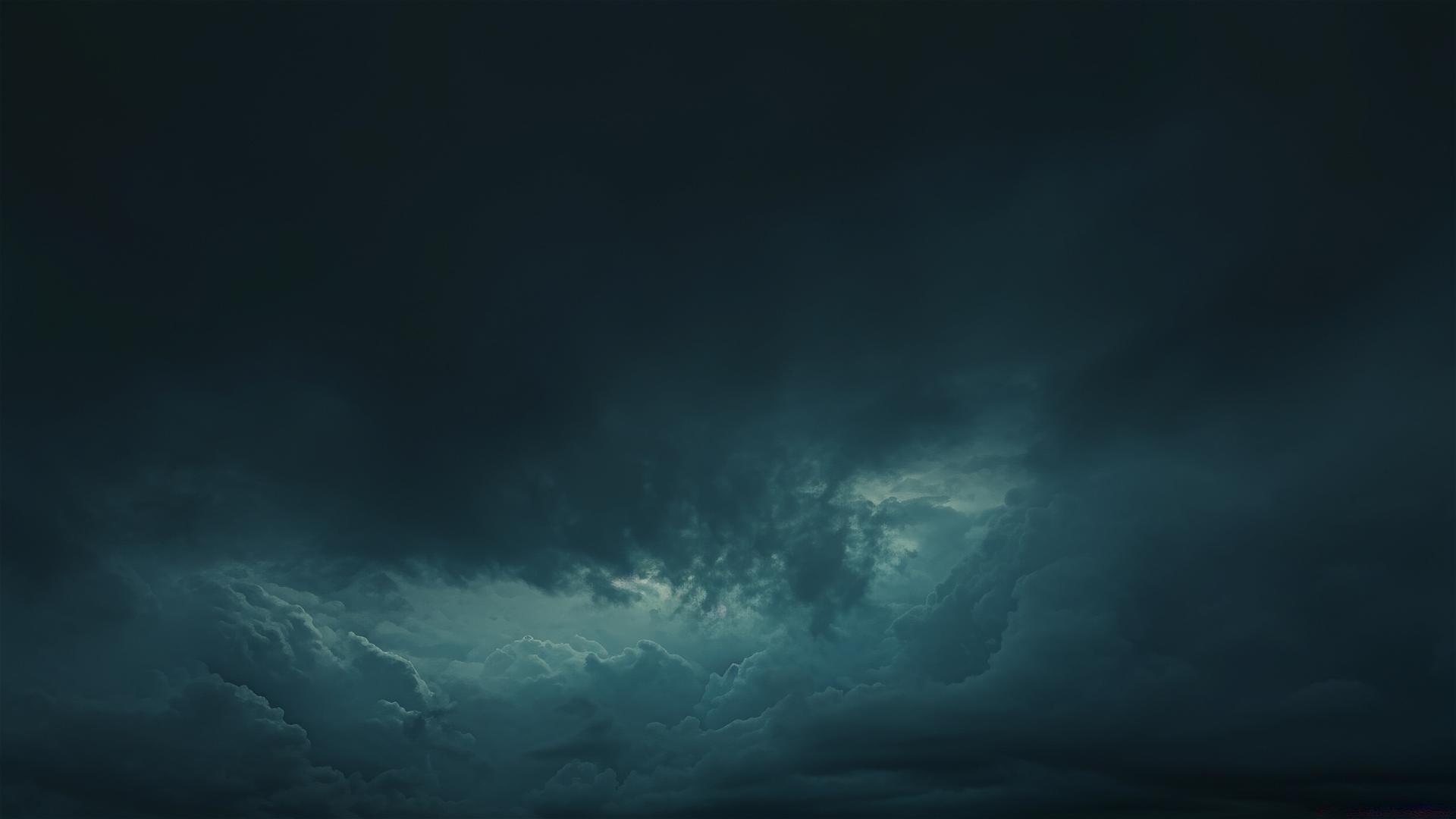 A faint black cloud drifts in the dark night sky, adding soft texture to the serene scene