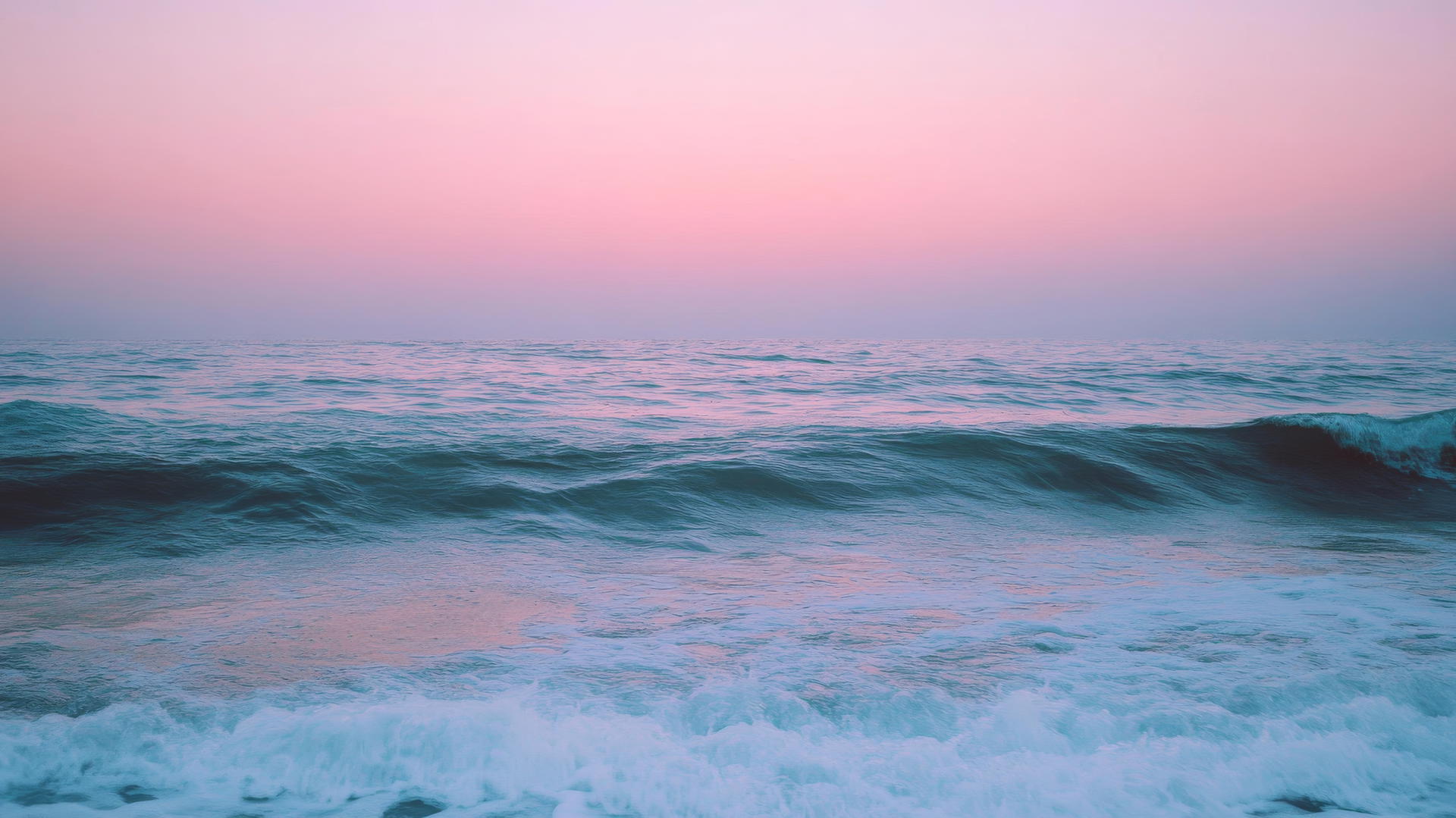 nature aesthetic wallpaper of a calm ocean with gentle waves and a pastel-colored sky at dusk