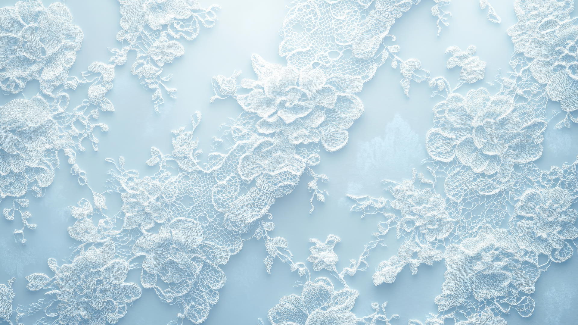 light blue wallpaper with intricate lace pattern on pale blue background