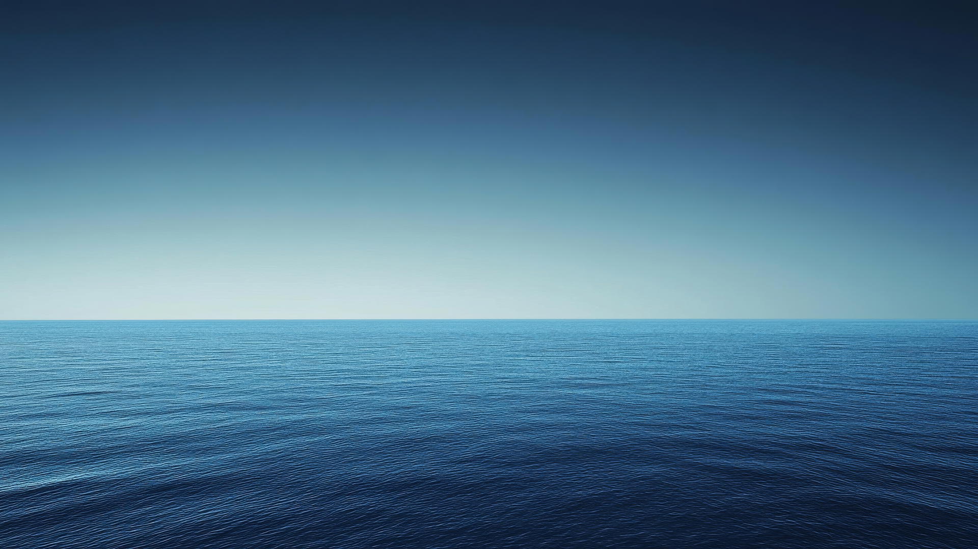 blue background wallpaper with gradient from navy blue to sky blue resembling ocean horizon at dusk.