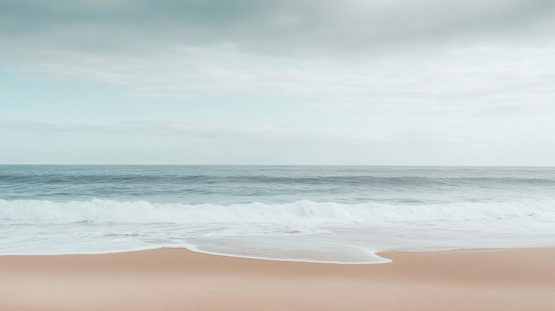 beach wallpaper aesthetic with smooth sand, gentle waves, and a soft, cloudy sky