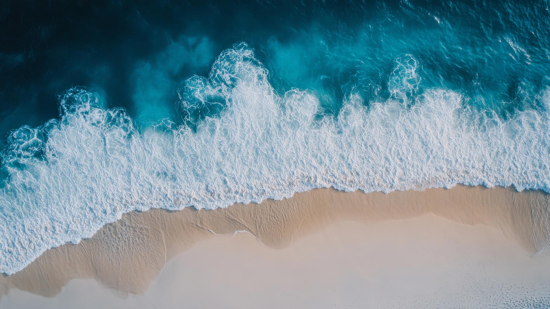 Overhead drone shot of beach with white sand and blue ocean waves, beach pictures wallpaper