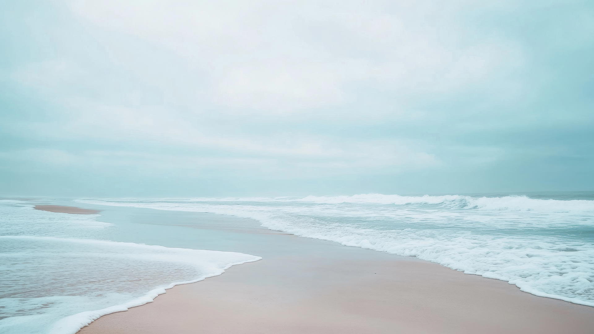 Beach wallpaper aesthetic: minimalist and stylish background with smooth sand and gentle waves under a cloudy sky.