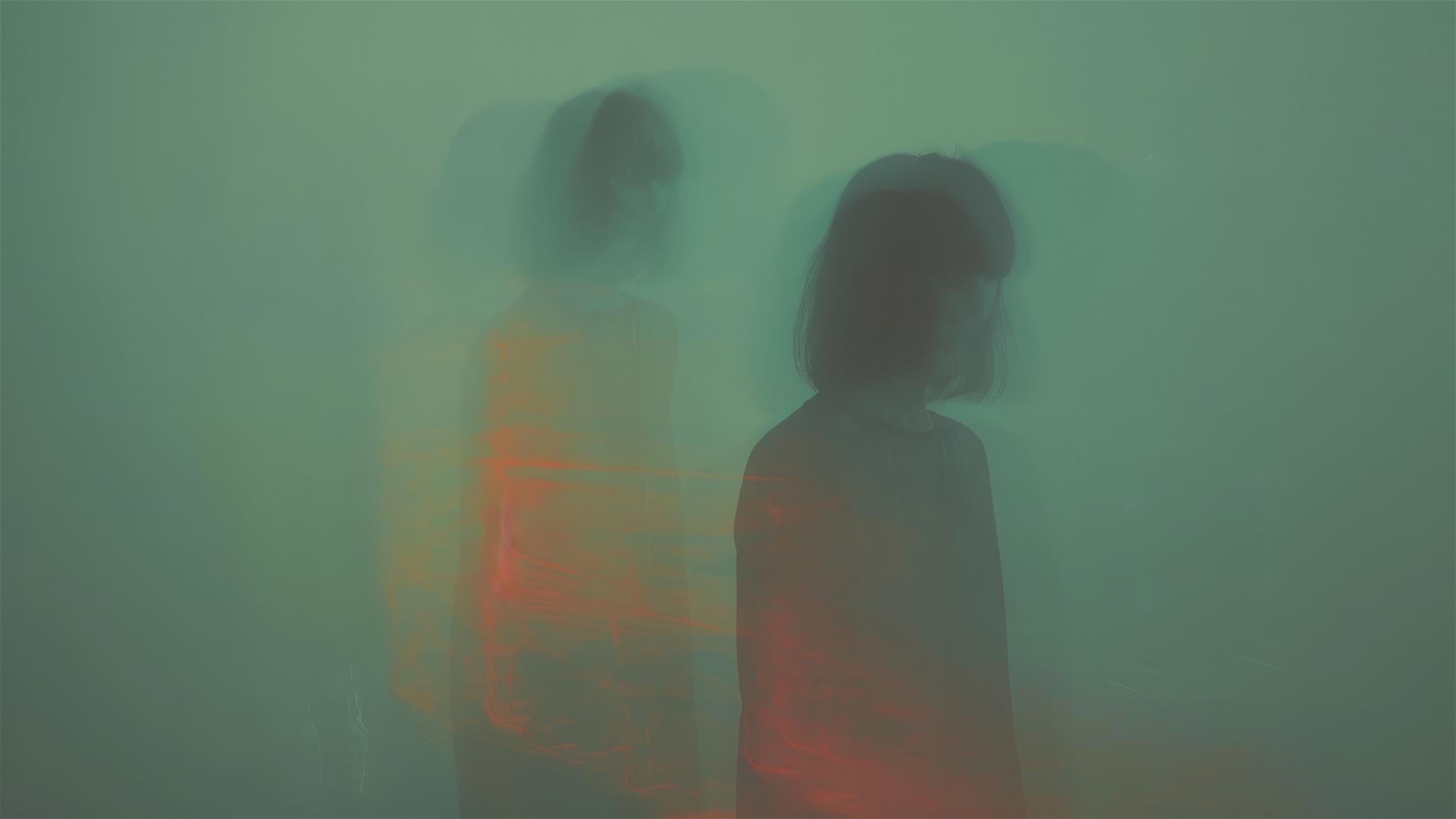 Dual figures with ethereal light, soft focus and neon shadows