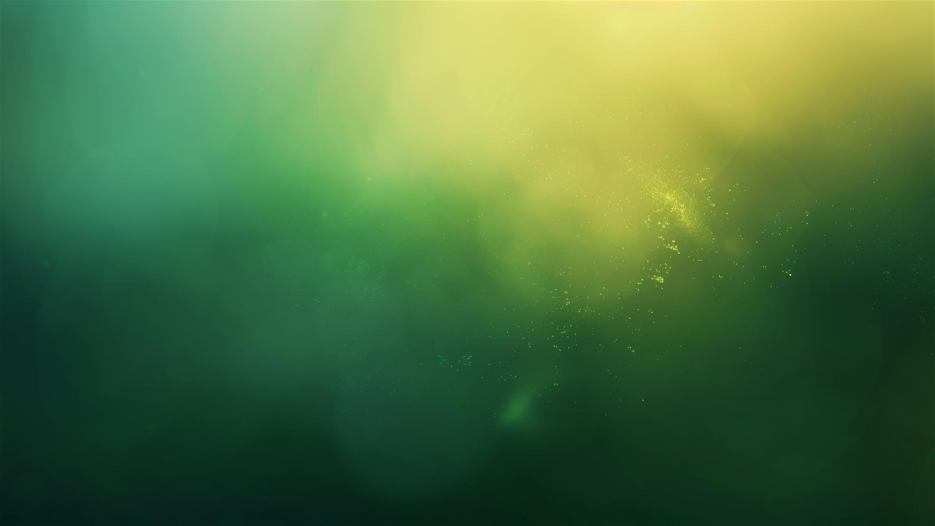 Green shaded gradient background with color hints, blurred