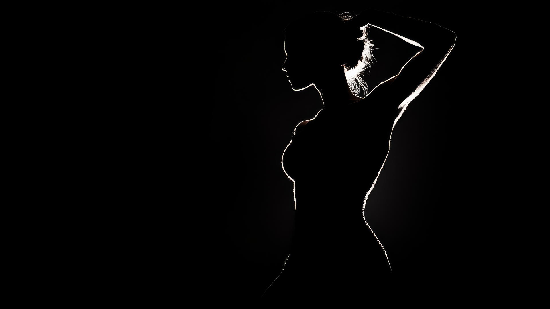 Aesthetic black wallpaper with a dancer's silhouette in dramatic lighting