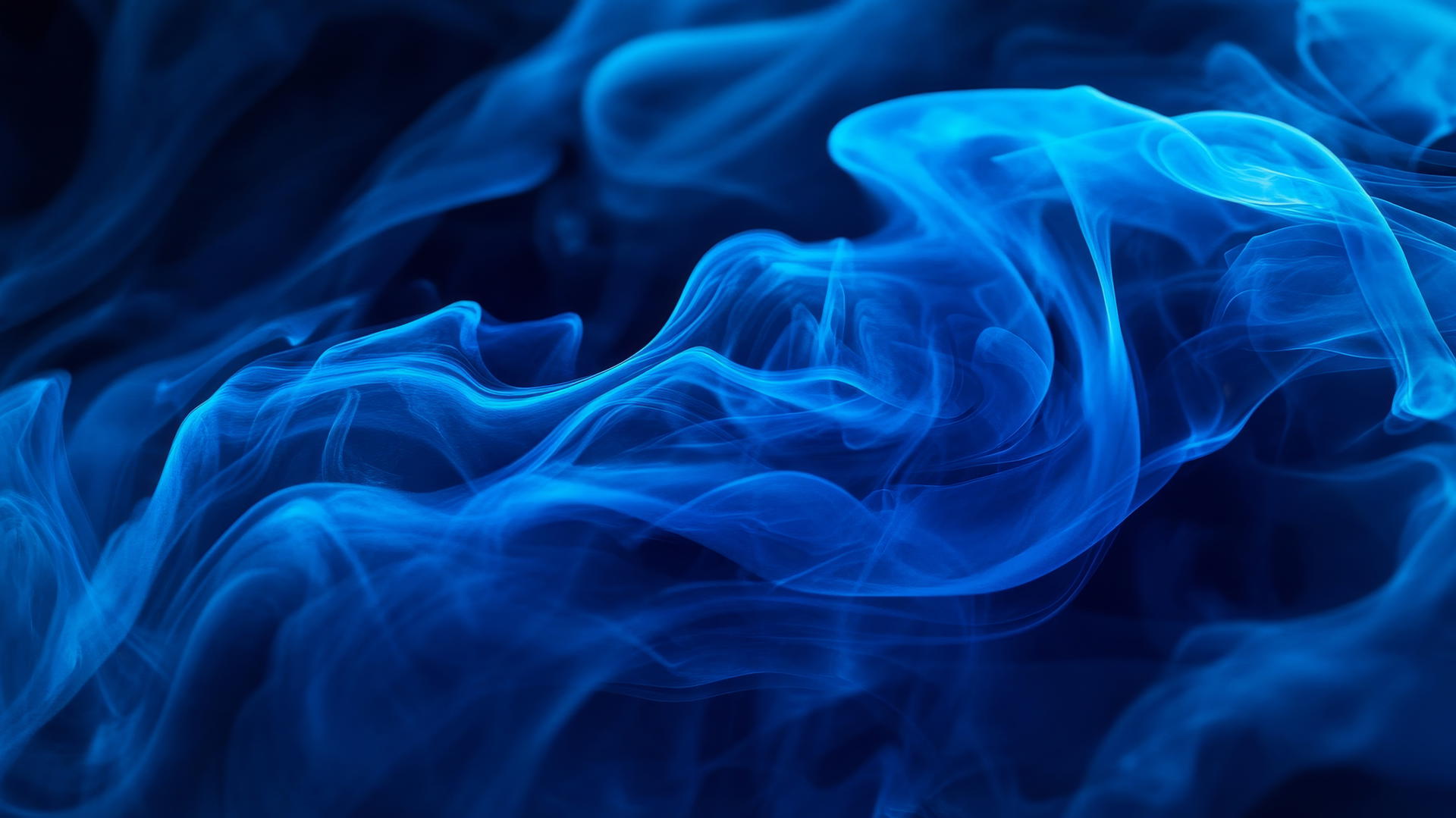 Abstract royal blue smoke swirling against a dark background