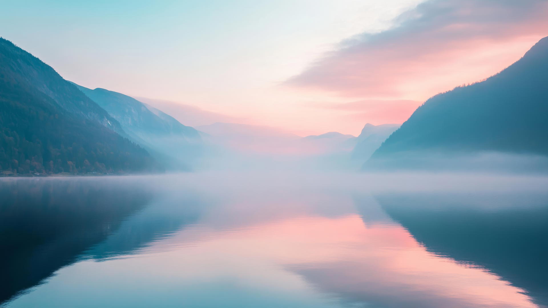 Nature wallpaper of serene sunrise over misty mountains reflecting on calm lake