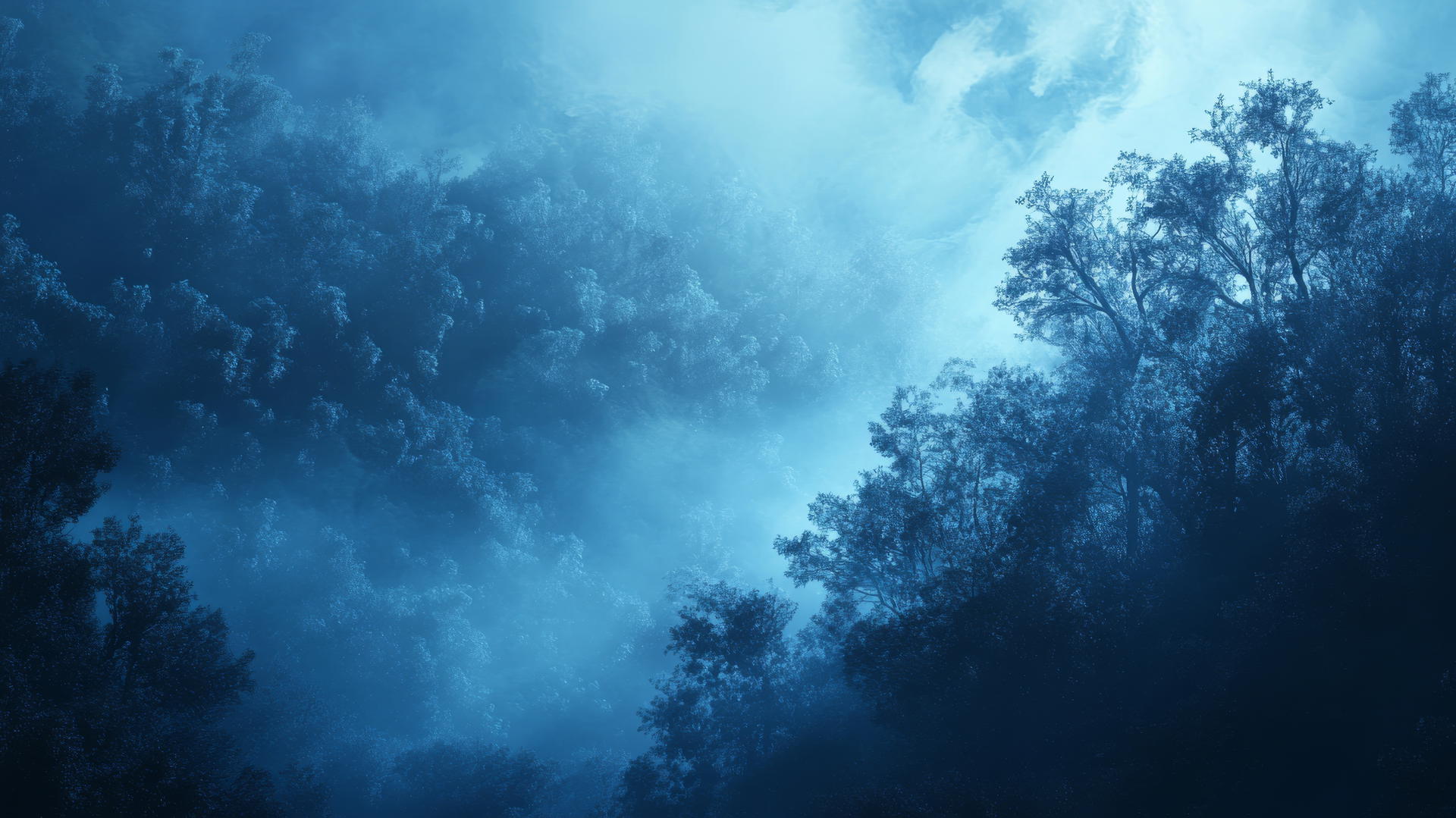 Aesthetic blue wallpaper with ethereal fog over a forest landscape