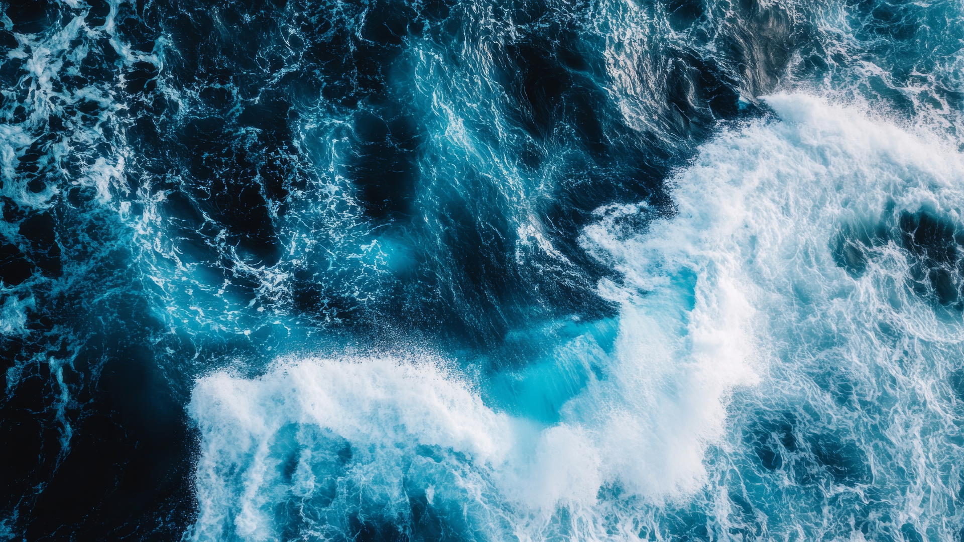 wallpaper blue showcasing powerful ocean waves crashing against rugged rocks
