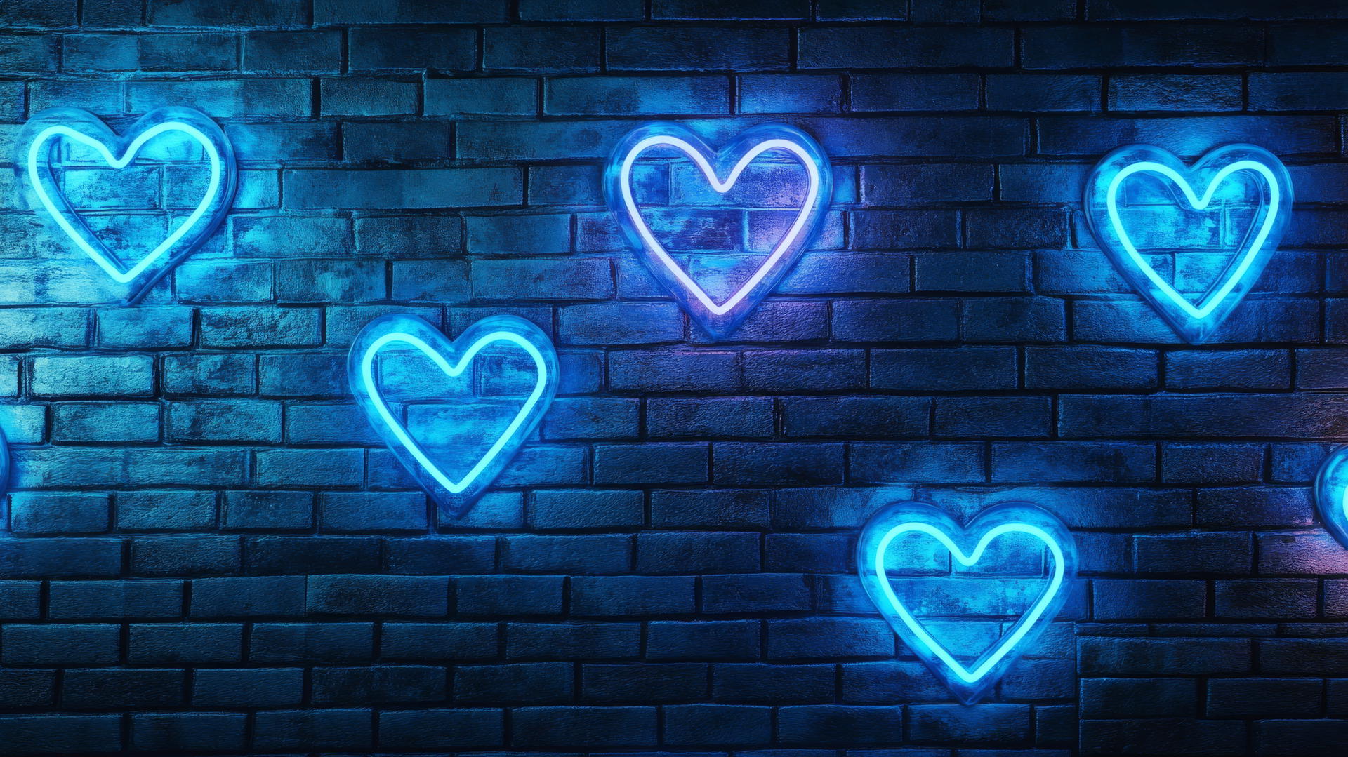 neon blue heart signs glowing against a brick wall